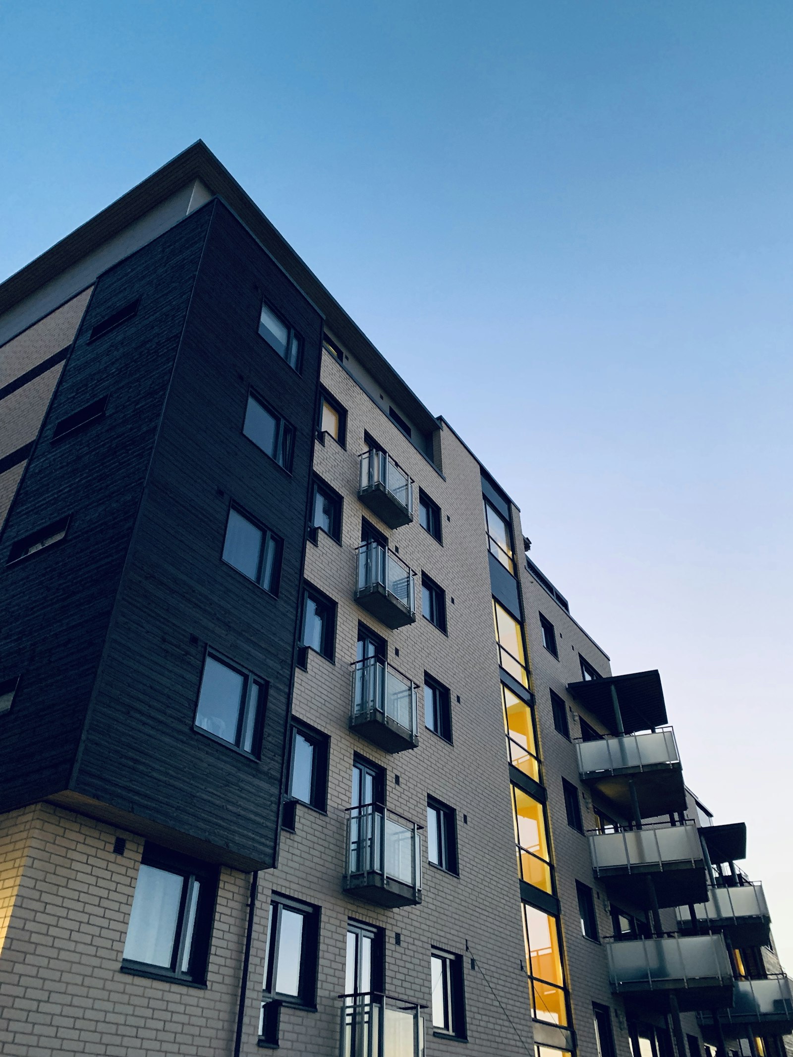 Modern self-managed strata apartment building at dusk